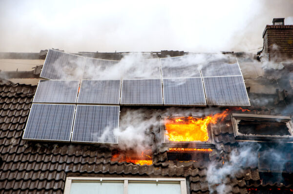 Solar panels on fire on a house roof