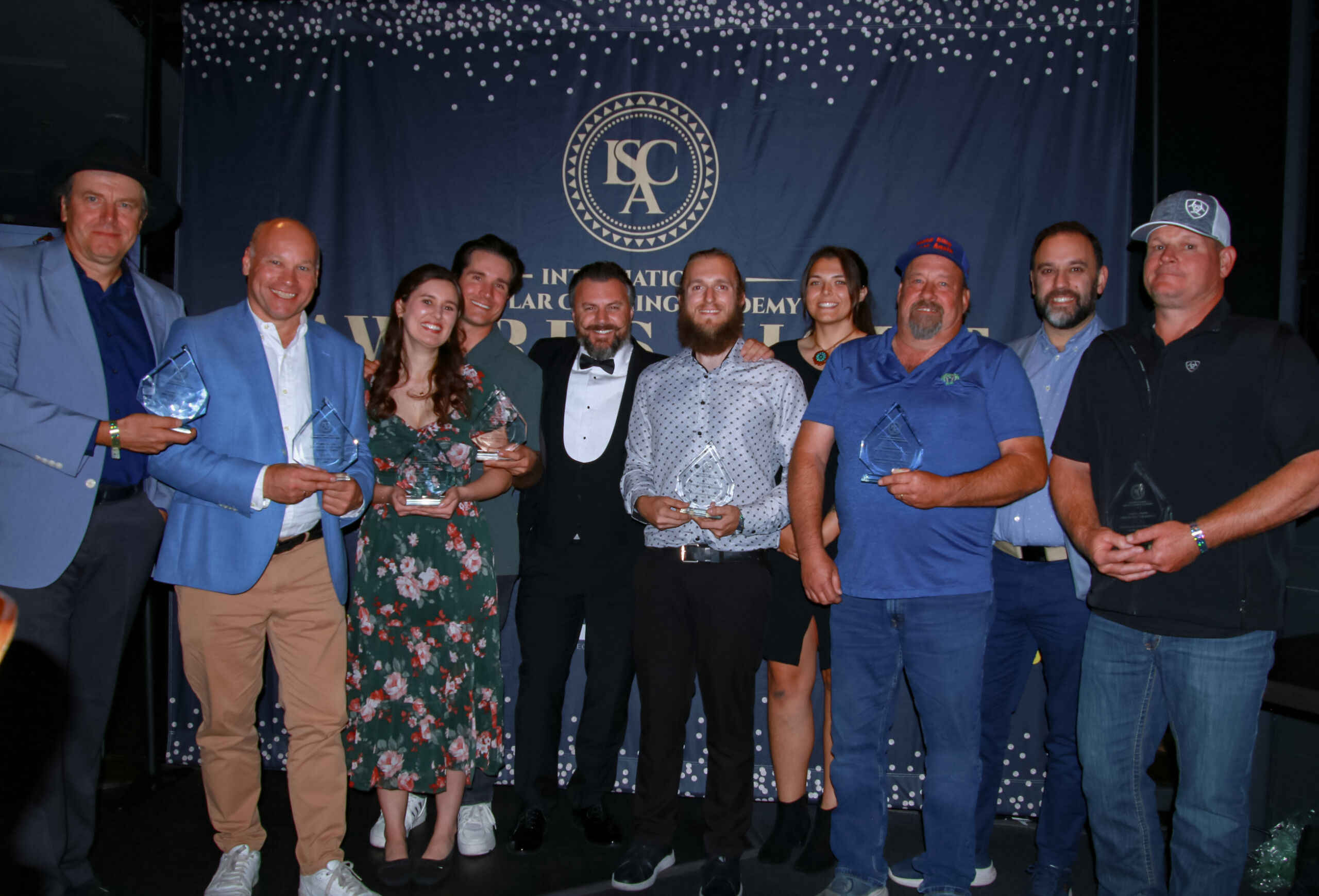 A group of people holding their glass awards