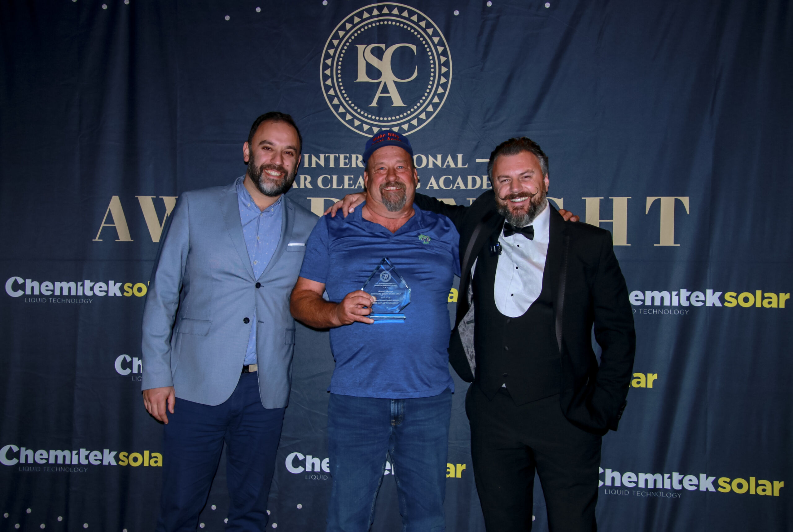 3 people receiving glass award