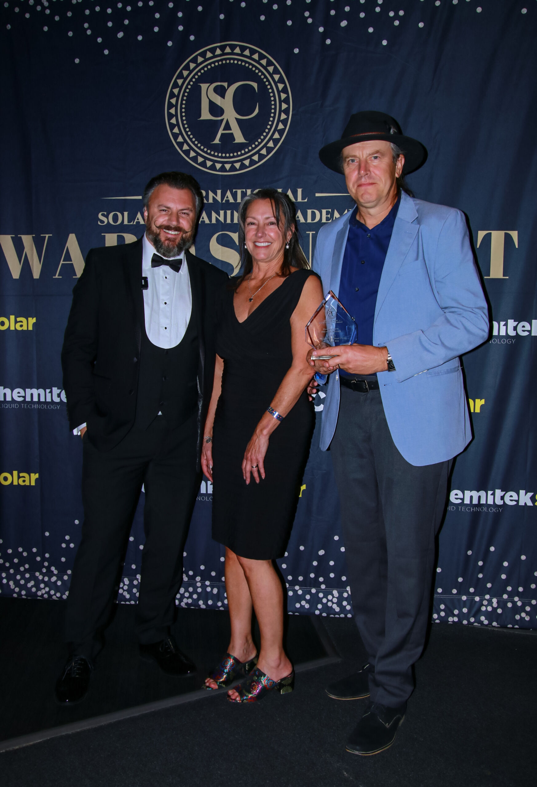 3 people receiving glass award